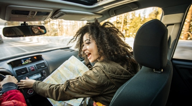 Woman looking at map in a car